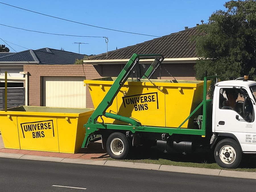 Universe Bins skip truck delivering yellow skip bins to a Melbourne home